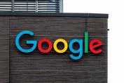 Colorful Google logo displayed on a brick wall of a building