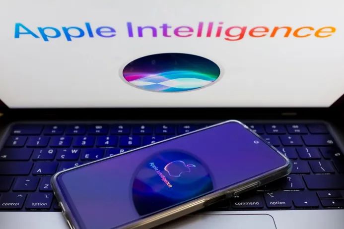 A smartphone displaying the Apple Intelligence logo in front of a laptop with the Apple Intelligence text on the screen.