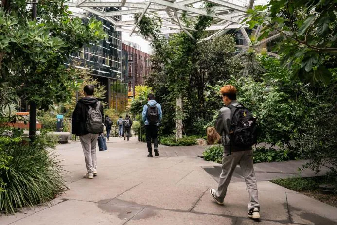 students-walking-through-garden-path
