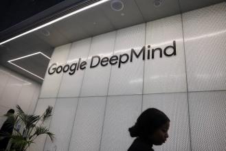 Entrance sign of Google DeepMind with a person walking past