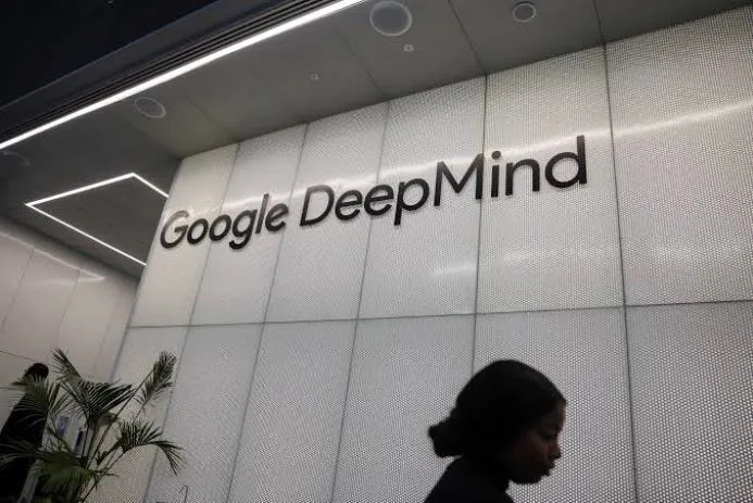 Entrance sign of Google DeepMind with a person walking past