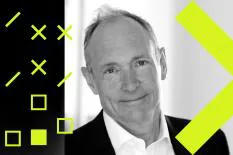 A smiling man in a suit against a creative background featuring geometric shapes.