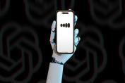 robot hand holding smartphone