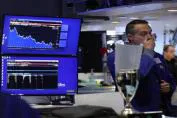 A stock market trader monitoring financial data on screens, with charts showing market trends and analysis.